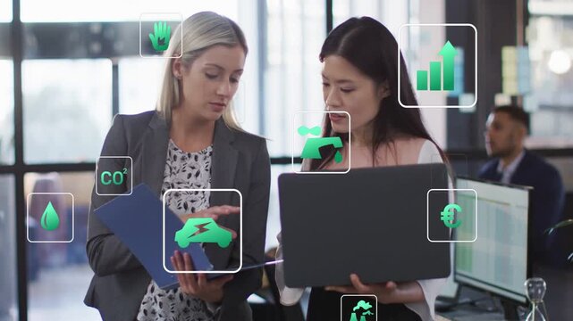 Vertical video: Flipping blue folder office women pointing, reviewing laptop data with green icons