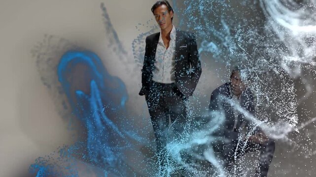 Vertical video: Two models fixing suits posing for style while blue white particles revealing faces