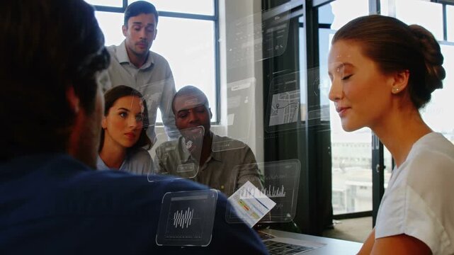Business lead speaking and gesturing, initiating UI charts over laptop while team reading document