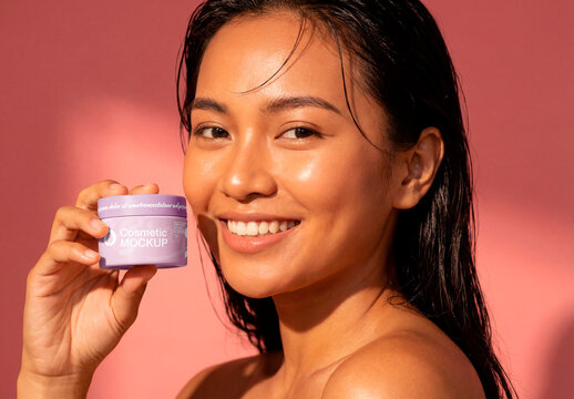 Smiling woman holding cosmetic cream jar skincare concept