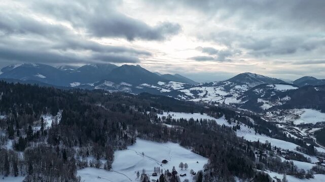 Aerial Hyperlapse of Snowy Mountain Range Under Dramatic Winter Sky