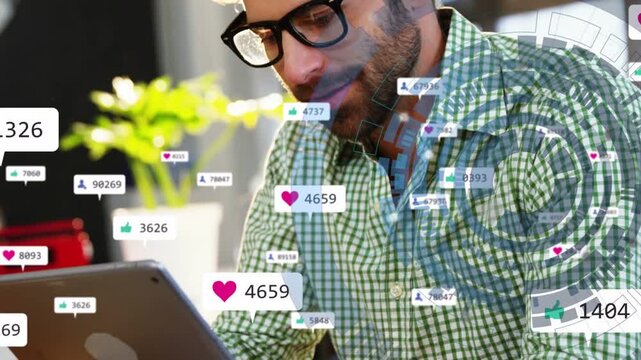 Man tapping tablet at desk, monitoring social engagement as hearts and follower badges multiplying