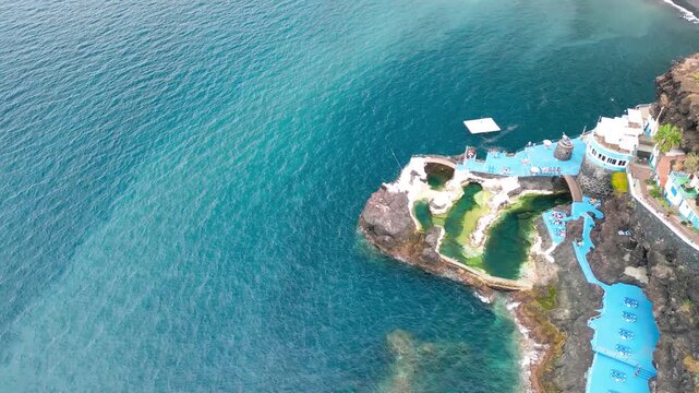 Aerial summer view of Doca do Cavacas in Madeira, capturing turquoise waters, moored boats, and vibrant coastal scenery