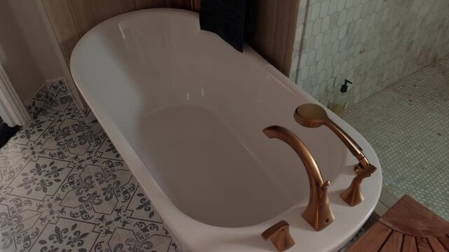 Steady pan across bathtub and glass shower in clean modern bathroom