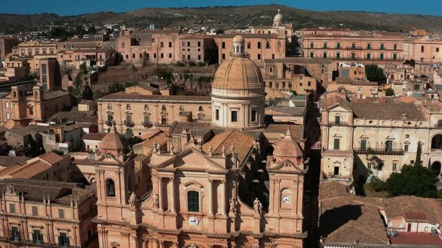 Camera slowly pushes back from the ornate Baroque front facade of Noto Cathedral Sicily