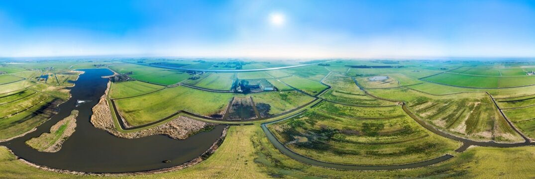Aerial view of newly developed nature reserve and foraging area with wetlands, meadows, marshes and lakes, in 360 degrees panorama, Hoeksmeer, Groningen, Netherlands.