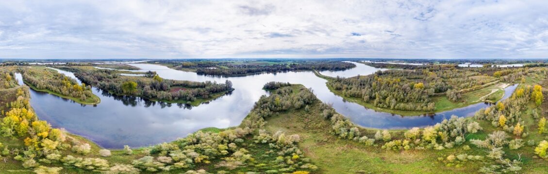 Aerial view of nature reserve in floodplains of river Waal with water streams, forest, grassland and bushes, in 360 degrees panorama, Millingerwaard, Gelderse Poort, Gelderland, Netherlands.