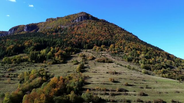 Drone shot of picturesque autumn countryside under blue sky