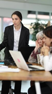 Standing girl scold to round table gathering female staff at office. Management committee, meeting of working business group, board of business representatives