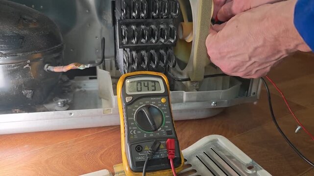 Repairing a refrigerator electrical issue with a multimeter in a home setting