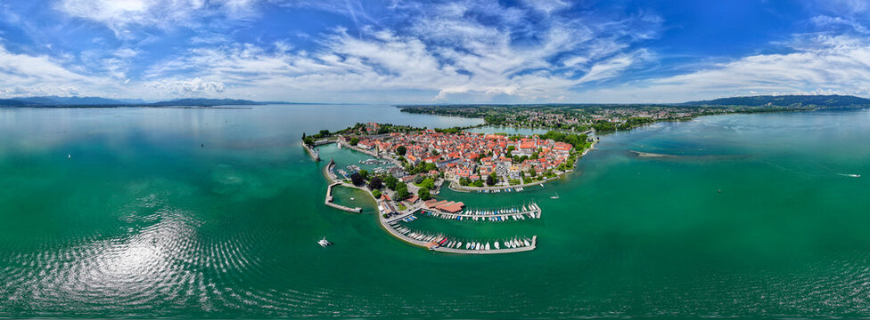 Aerial view of Lindau, a vibrant island city, where red-roofed buildings meet the shimmering turquoise waters of Lake Constance, Lindau, Bavaria, Germany.