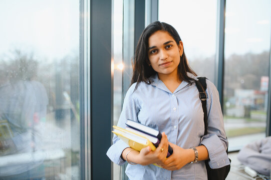 Indian student girl holding books preparing for study