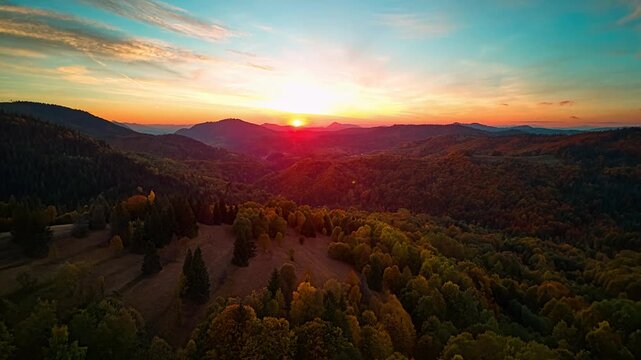 Aerial hyperlapse of sunset over autumn mountain forest