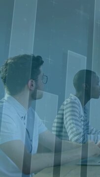 Vertical video: Two analysts watching right deck, reading finance candles overlay for market review