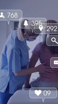 Vertical video: Nurse placing hand on patient back, doing medical exam while hearts obscuring view
