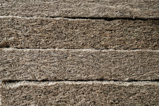 Stacked kenaf fiber insulation panels with natural textured surface