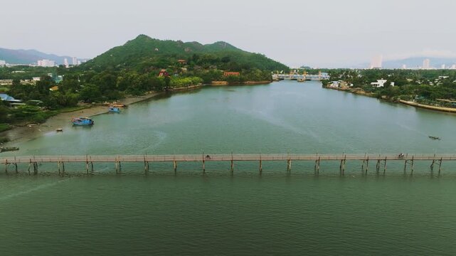 Aerial 4K of traditional Phu Kien wooden bridge crossing Cai River, Nha Trang, Vietnam
the authentic charm of rural Vietnam, highlighting the traditional engineering, peaceful tropical landscape