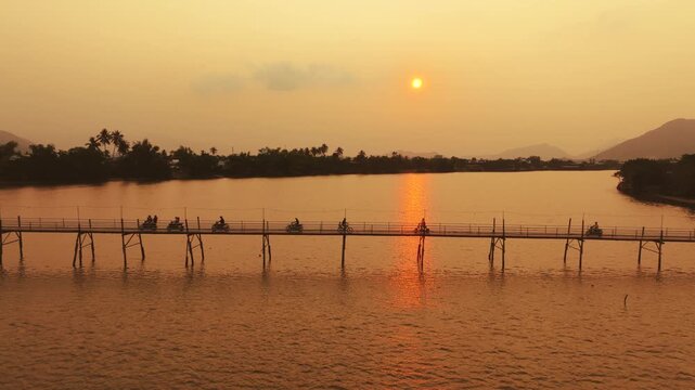 Aerial 4K of traditional Phu Kien wooden bridge crossing Cai River, Nha Trang, Vietnam
the authentic charm of rural Vietnam, highlighting the traditional engineering, peaceful tropical landscape
