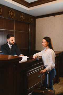 Guest checking in at hotel reception desk