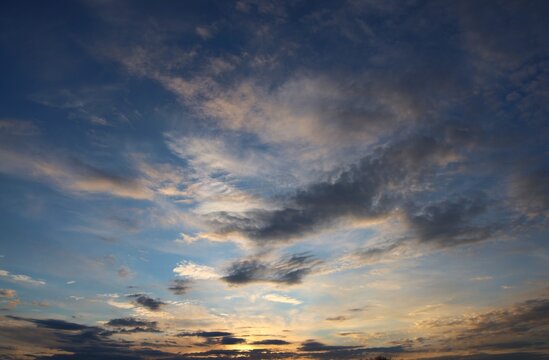 beautiful evening sky with layered clouds illuminated by warm sunset light soft