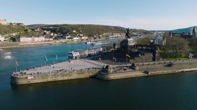 Aerial view of the Deutsches Eck where the Mosel joins the Rhine, shadowed by Ehrenbreitstein Fortress, creating a contrast of history and nature, Koblenz, Rhineland-Palatinate, Germany.