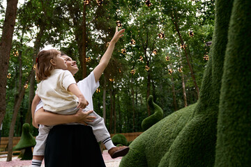 Fototapeta premium Joyful moments in an enchanting amusement park with mother and daughter