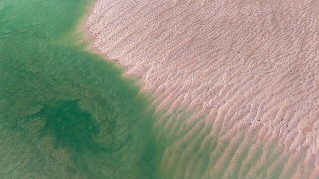 Aerial view of turquoise waters meet rippled sands in a dance of light and shadow, creating a mesmerizing coastal mosaic, Broome, Western Australia, Australia.