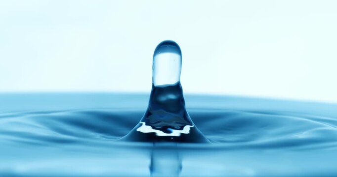 Drop of water falls into a drop of water in a super slow motion. Shot on super slow motion 1600 fps.