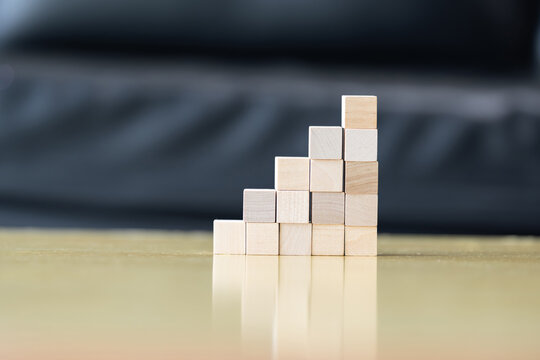 Wooden blocks rising steps child behind patience effort planning strategy step progress focus control consistency logical development achievement.