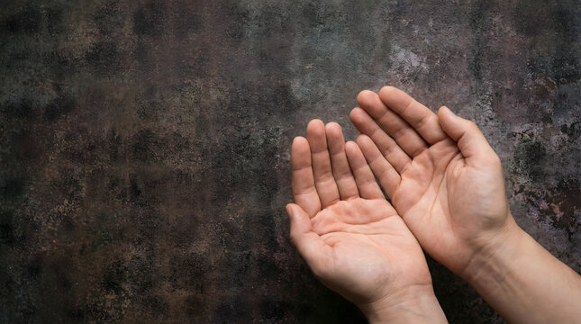 palm up hands gesture on dark background