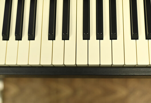 Close-up of black and white electronic piano keys with soft lighting, modern music technology concept