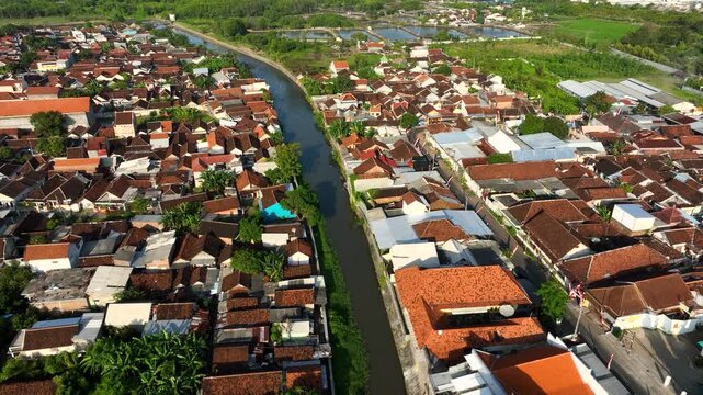Aerial view of Banyuwangi town, East Java reveals a canal and rooftops