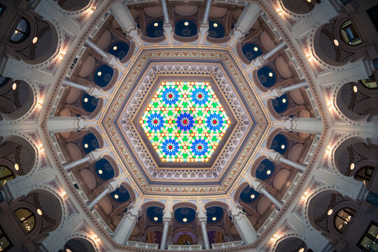Sarajevo, Bosnia and Herzegovina - 07 May 2025: View of the Vijecnica's intricate ceiling, where vibrant stained glass dances with ornate architectural details.