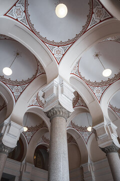 Sarajevo, Bosnia and Herzegovina - 07 May 2025: View of the Ashkenazi Synagogue's interior, where ornate arches meet mosaic-clad columns beneath softly lit domes.