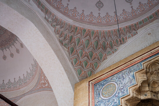 Sarajevo, Bosnia and Herzegovina - 07 May 2025: View of intricate geometric patterns and decorative calligraphy adorn the interior dome of Gazi Husrev-beg Mosque, bathed in soft light.