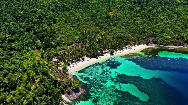 A secluded Tropical Beach resort with turquoise waters and dense jungle foliage, Ideal for travel promotions. Port Barton Beach