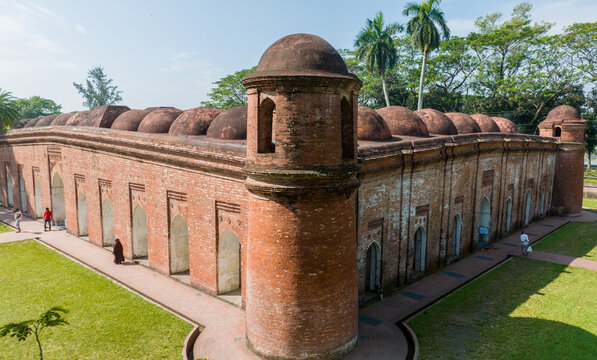Aerial view of the Sixty Dome Mosque, a UNESCO World Heritage Site, stands with its terracotta brickwork amidst the vibrant green lawns, Bagerhat, Khulna Division, Bangladesh.