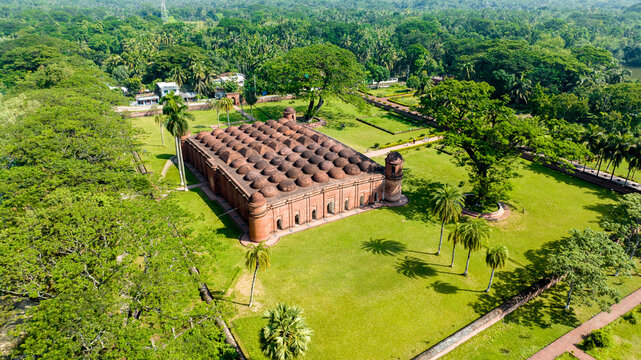 Aerial view of the Sixty Dome Mosque, a historical landmark with its many domes contrasting against the lush green surroundings, Bagerhat, Khulna Division, Bangladesh.