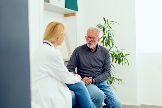 Doctor Consultation With Senior Male Patient In Medical Office Discussing Health And Care Options