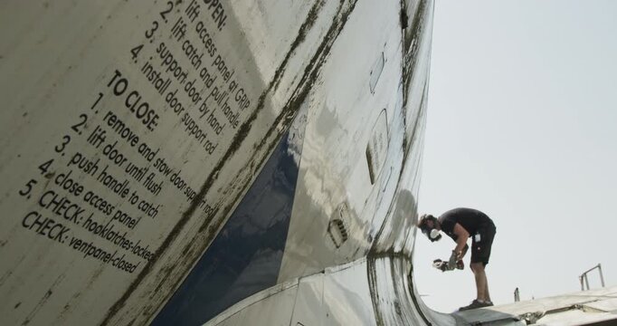 High angle view of a commercial aircraft fuselage section with windows being transported in a yard