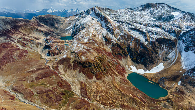 Aerial view of the majestic mountains, with snow-dusted peaks surrounding serene turquoise lakes, creating a breathtaking panorama, Neelum Valley, Azad Kashmir, Pakistan.