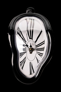 Melting clock on black background	
