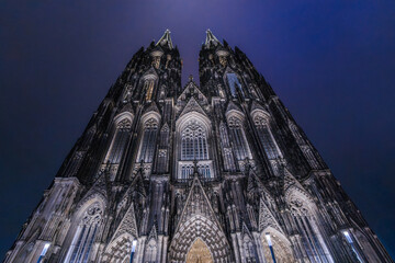 Illuminated Cologne Cathedral facade at night with dramatic gothic towers  © StockMediaSeller