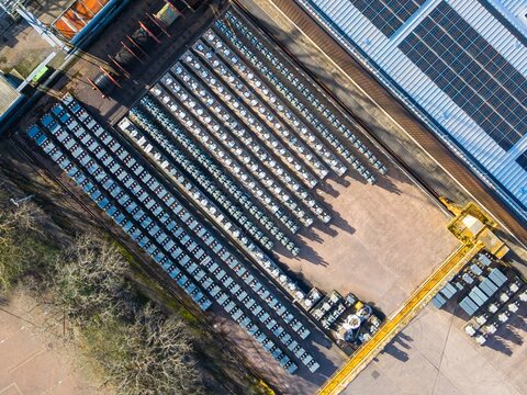 Aerial view of rows of air conditioning units casting stark shadows on the ground, a geometric dance of light and industrial form, Exeter, England, United Kingdom.