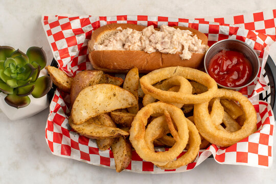 tuna salad boat  with potatoe wedges and frenchonion rings