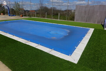 Swimming pool tarp protecting backyard residential area © tonifrito