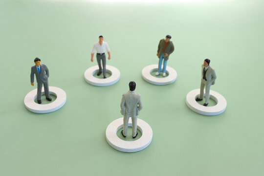 miniature figure forming teamwork. Concept of leadership, business, and challenge