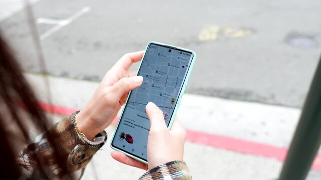 Woman using smartphone gps navigation app in san francisco city