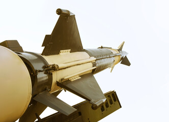Obraz premium Anti-aircraft cruise missiles on a launcher on blue sky background missiles are aimed to sky at day Nuclear bomb, chemical weapons, missile defense system of salvo fire Metallic missile rocket