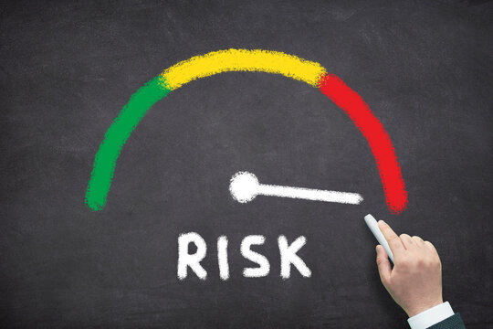 High level risk meter. Risk Assessment Gauge Showing Low to High Risk Levels on chalkboard